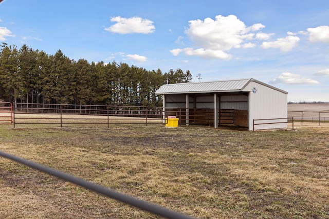 view of horse barn with a rural view