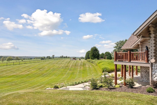 view of yard with a rural view and a wooden deck