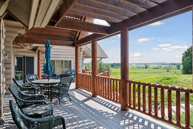 wooden terrace featuring a rural view and a pergola