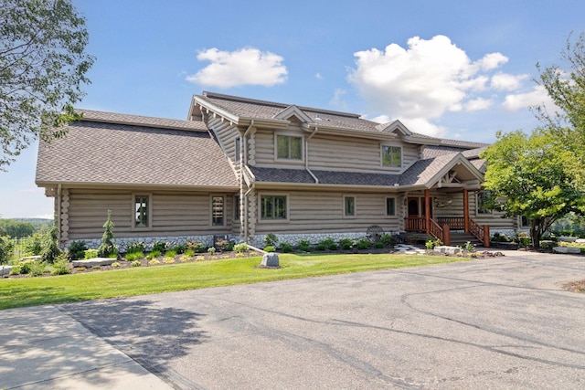 log-style house with a front lawn