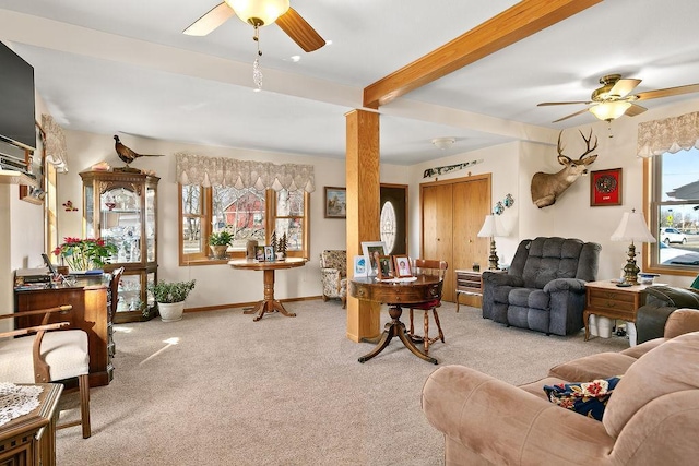 living room with beam ceiling, ceiling fan, and light colored carpet