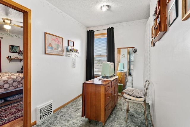 office area featuring light carpet and a textured ceiling