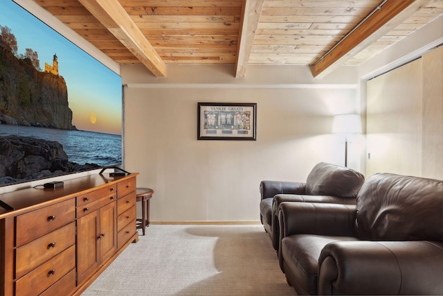 sitting room with beam ceiling, light carpet, and wooden ceiling