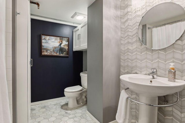 bathroom with tile flooring and toilet