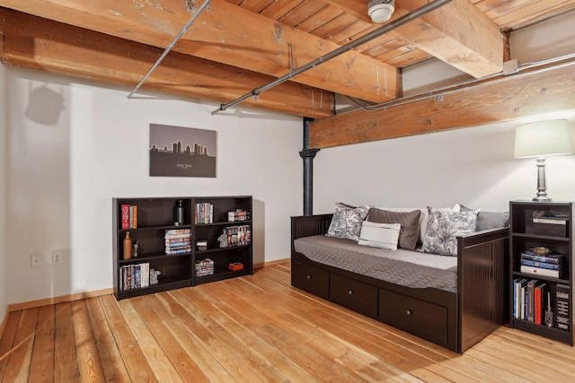 bedroom with wooden ceiling and light wood-type flooring