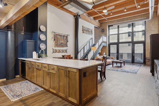 kitchen featuring ceiling fan, beamed ceiling, sink, dark hardwood / wood-style flooring, and track lighting