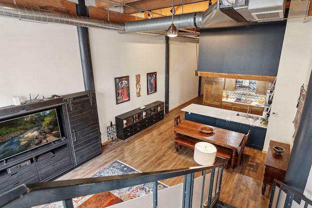 interior space with light hardwood / wood-style flooring and a high ceiling