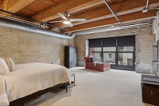 carpeted bedroom with ceiling fan, beam ceiling, brick wall, and wooden ceiling