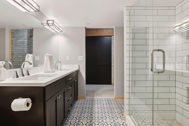 bathroom featuring tile flooring, double sink vanity, and an enclosed shower