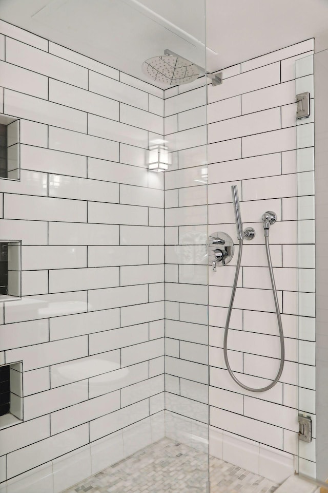 bathroom with tiled shower