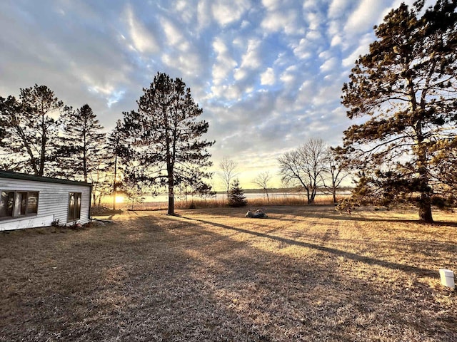 view of yard at dusk