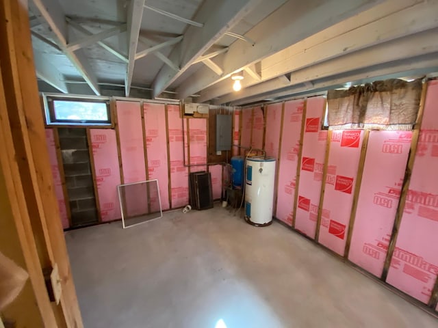 basement featuring electric water heater and electric panel