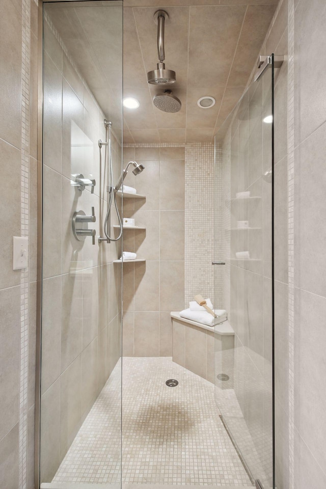 bathroom featuring a shower with door