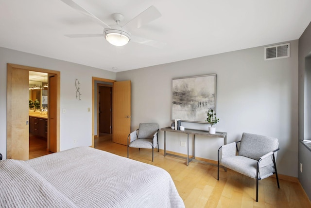 bedroom with connected bathroom, light wood-type flooring, and ceiling fan