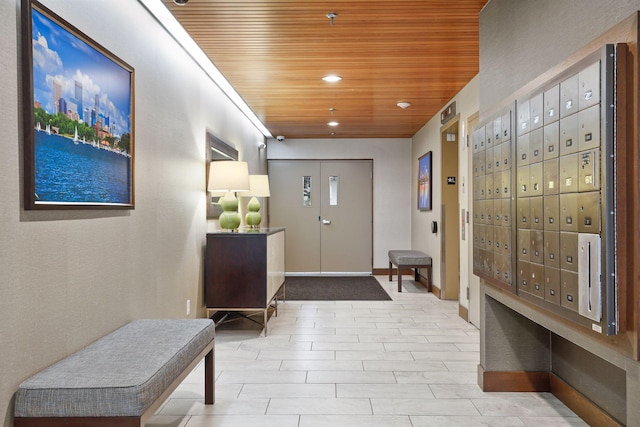 interior space featuring wood ceiling and a mail area