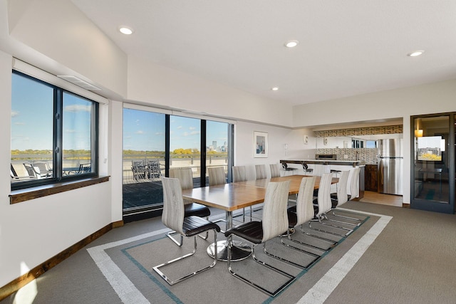 carpeted dining area with a wealth of natural light