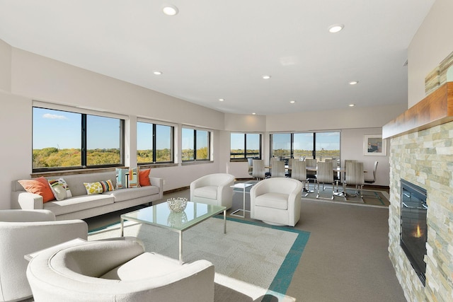 carpeted living room with a fireplace and plenty of natural light