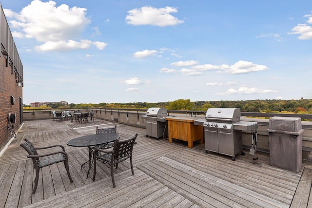 wooden terrace with a grill