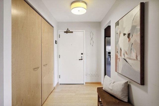 hallway with light hardwood / wood-style flooring