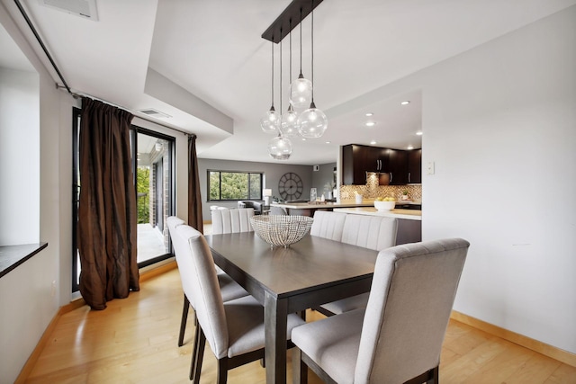 dining area with light hardwood / wood-style floors