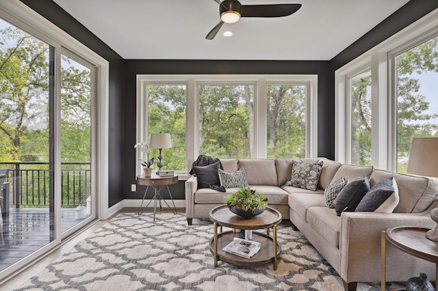 sunroom / solarium featuring plenty of natural light and ceiling fan