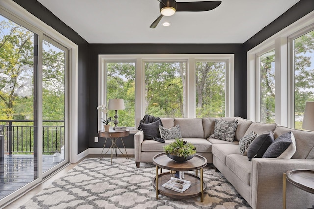 sunroom / solarium featuring plenty of natural light and ceiling fan