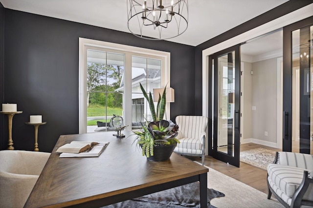 office area with an inviting chandelier, light wood-type flooring, and french doors