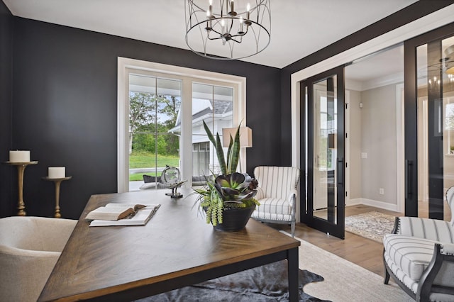 office with a notable chandelier, light hardwood / wood-style floors, and french doors