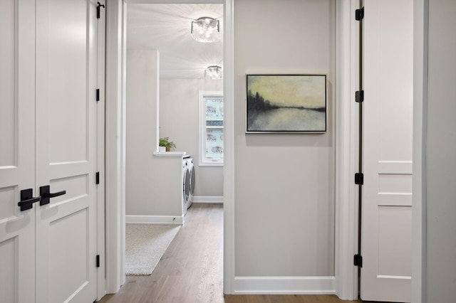 hallway featuring light hardwood / wood-style flooring and washing machine and clothes dryer