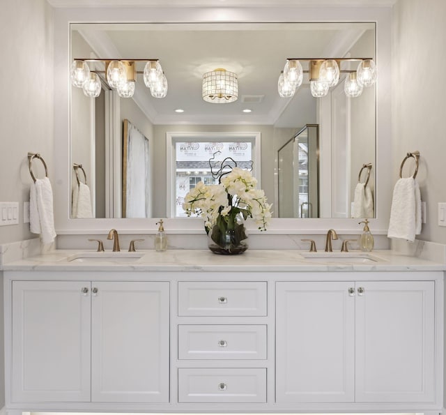 bathroom with dual vanity and crown molding