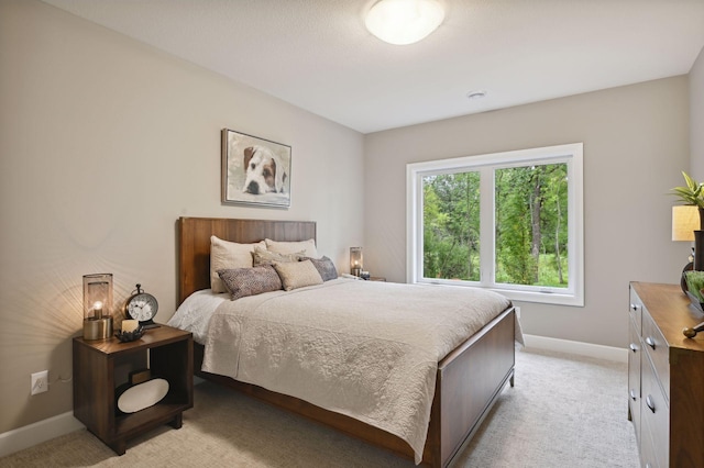 bedroom featuring light colored carpet