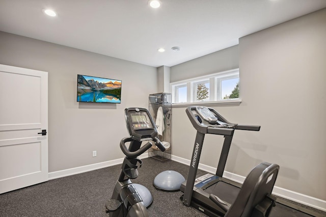 exercise area featuring dark colored carpet