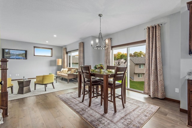 dining area with a chandelier and hardwood / wood-style flooring