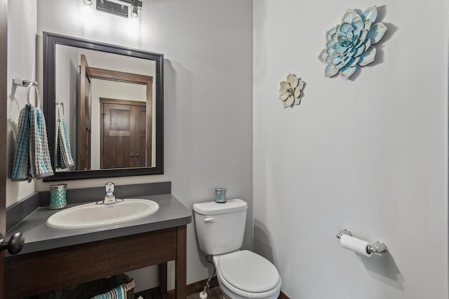 bathroom featuring toilet and vanity