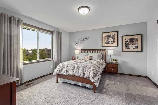 bedroom featuring multiple windows, a textured ceiling, and light carpet