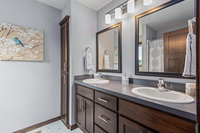 bathroom featuring tile flooring and double vanity