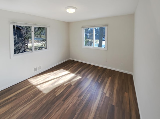 unfurnished room featuring dark wood-type flooring