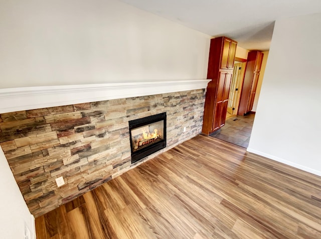 unfurnished living room featuring a fireplace and light hardwood / wood-style flooring