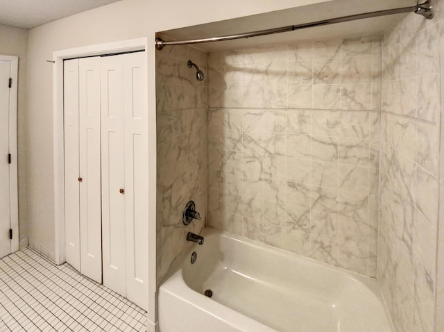 bathroom with tile patterned flooring and tiled shower / bath