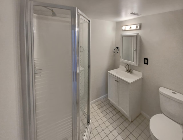 bathroom featuring tile patterned floors, vanity, toilet, and a shower with door