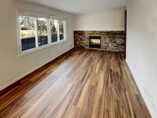 unfurnished living room with a fireplace and hardwood / wood-style flooring