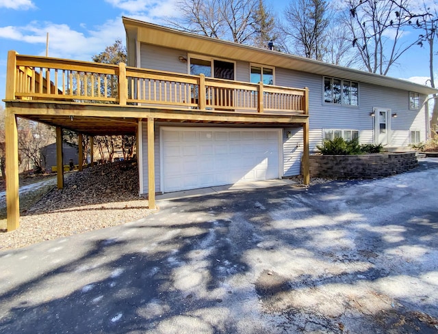 view of front of property with a wooden deck and a garage