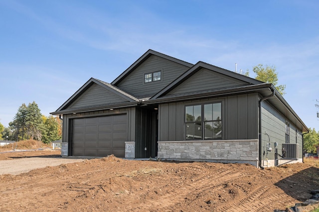 view of front of house with central AC unit and a garage