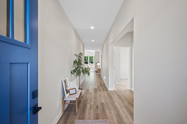 hallway with light hardwood / wood-style floors