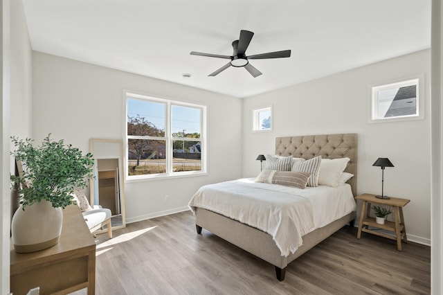 bedroom with ceiling fan and hardwood / wood-style flooring