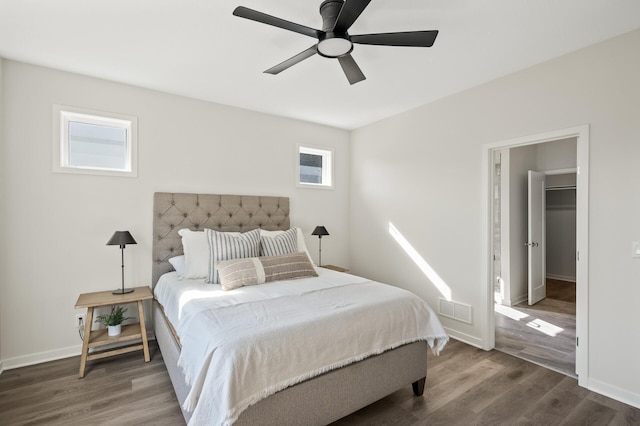 bedroom featuring ceiling fan, hardwood / wood-style flooring, and a spacious closet