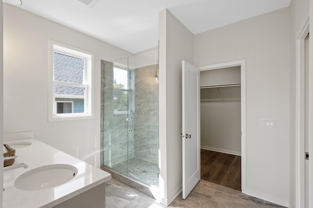 bathroom featuring vanity, hardwood / wood-style floors, and a shower with door