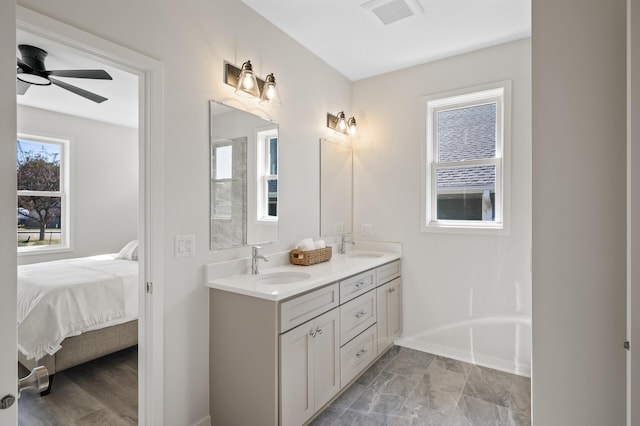 bathroom featuring ceiling fan and vanity