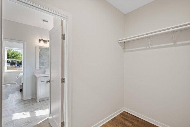 spacious closet featuring hardwood / wood-style flooring