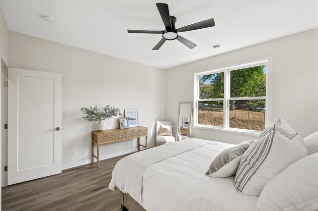 bedroom featuring ceiling fan and dark wood-type flooring